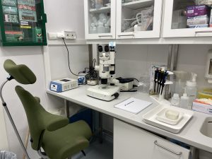 Photo of a work station with a bench, a microscope and various lab equipment
